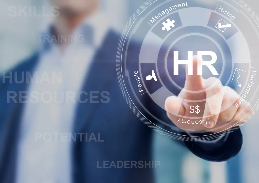 70543593_m A business professional interacts with a digital HR interface, highlighting terms like management, hiring, and performance metrics.